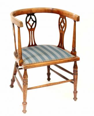 An Edwardian mahogany inlaid tub chair with slatted back slates and side, blue striped upholstered seat.