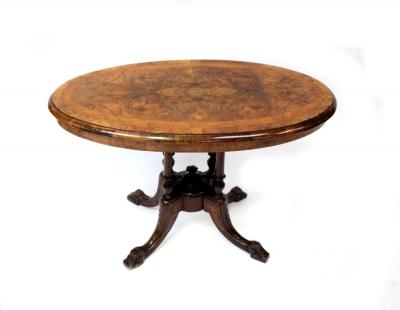 A Victorian burr walnut crossbanded and line inlaid oval occasional table, raised on four turned columns to central lower section and four outswept feet, length 94cm.