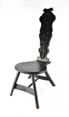 A mid-19th century ebonised spinning chair, cylinder back with oak leaf and Tudor rose decoration to splayed supports and cross-stretcher, inscribed to the back JGL 1853.
