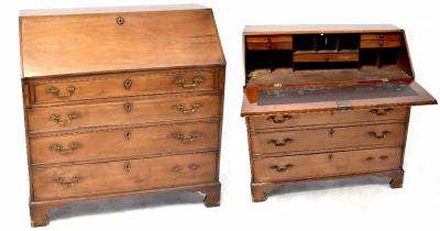 A 19th century bureau desk with drop-down desk top with interior drawers and pigeonholes with small turned knobs, narrow frieze drawer above three drawers to bracket supports, height 111cm, width 101cm.