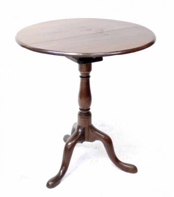 A George III mahogany tilt-top occasional table with birdcage action, on a baluster turned column and tripod cabriole base, diameter 63cm.