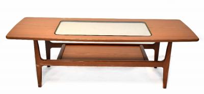 A Schreiber teak coffee table of rectangular form with inset smoky glass centre above undershelf, on square legs, 44 x 135 x 49cm.