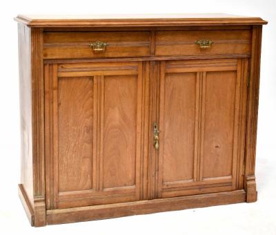 An Edwardian mahogany dresser base comprising two drawers and a pair of fielded and panelled cupboard doors on a plinth base, 83 x 107 x 40cm.