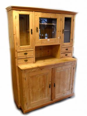 A Dutch pine dresser, the top with glazed cupboard doors and small drawers above a base with pair of cupboard doors with brass fittings, on bun feet, 194 x 140 x 56cm.