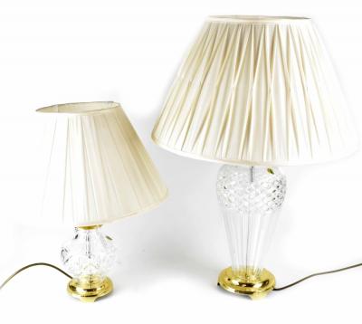 Two Waterford Crystal table lamps, one baluster vase shaped with turned brass neck on a spreading circular footed base, height 42cm and a smaller ovoid example with brass neck and collar to a circular brass base, height 30cm, with original Waterford Crystal labels (2).