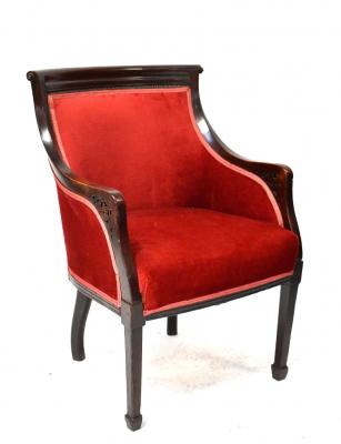 An Edwardian mahogany tub armchair with scroll top rail and overstuffed seat and back upholstered in red velour, on square tapering legs with spade feet.