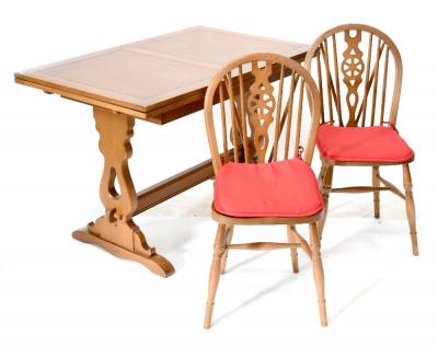 A 20th century oak draw-leaf table with country-style carved slab end supports to cross-stretcher, width 71cm, length when extended 174cm and six matching country-style wheel back chairs (7).