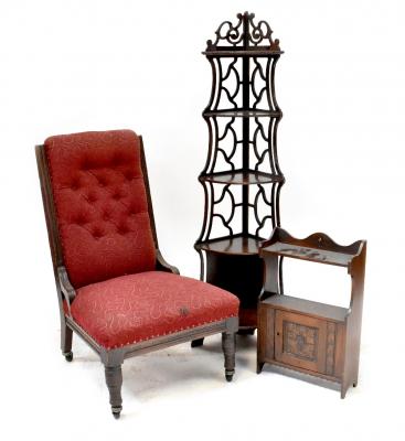 An Edwardian oak-framed nursing chair with button back red upholstery, a reproduction five-tier corner whatnot, height 138cm and a small carved oak wall shelf with cupboard door (3).