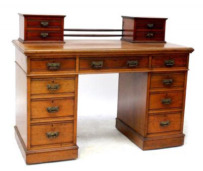 An Edwardian mahogany desk, converted from a dressing table, the top with a pair of small banks of drawers above a base of one long and four short graduated drawers, on plinth base, 95 x 122 x 56cm.