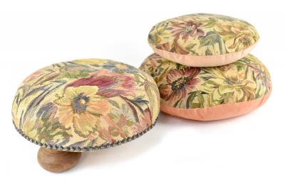 An Edwardian circular footstool on three bun supports, re-upholstered in floral tapestry-effect fabric and two matching circular cushions (3).