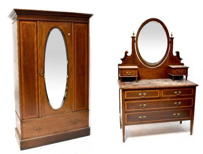 An Edwardian inlaid mahogany mirrored wardrobe with single door over a long drawer, on a plinth base 202 x 125 x 51cm and a matching dressing table with oval mirror and pair of trinket drawers above a base of two short and three long drawers, on square tapering legs 166 x 107 x 50cm (2).