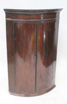 A George III mahogany inlaid wall hanging bow-front corner cupboard with two interior shelves, 107 x 74cm.