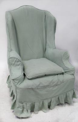 A Georgian-style oak wingback armchair with outswept arms, upholstered in a tapestry effect material with a green fitted cover, on cabriole legs.