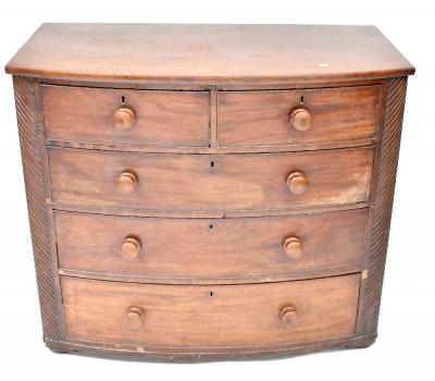 A Victorian mahogany bow-front two-over-three chest of drawers with decorative pillar to either side, 97 x 114 x 56cm.