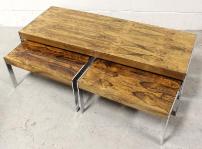 Merrow Associates; a c1970s nest of three rosewood and chrome tables, rosewood veneer within a chrome frame, largest 38 x 123cm, smallest 30 x 58cm. CITES certificate no.577466/02.