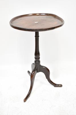 A George III oak occasional table with a lipped top, on a baluster turned column with tripod base, height 70cm, diameter 44cm.