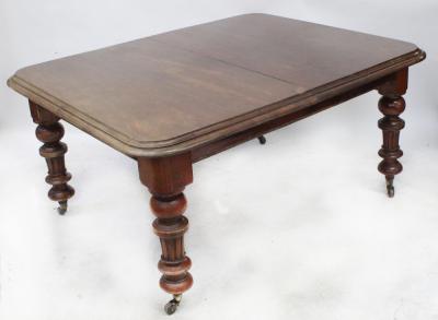 A 19th century mahogany wind-out dining table with rounded corners, on baluster and fluted column supports, with two extra leaves, when extended 74 x 238 x 119cm.