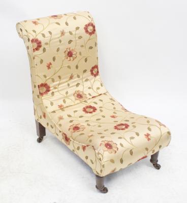 A Victorian walnut nursing chair upholstered in a modern embroidered satin fabric with red flowers, on turned feet, height 65cm.