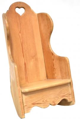 A rustic pine child's/doll's wing back rocking chair with heart-shaped motif to the back, height 62cm.