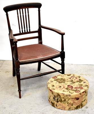 An Edwardian walnut inlaid open arm elbow chair with upholstered seat, turned spindle back and raised on turned stretchered supports to peg feet and a floral fabric covered circular hat box (2).