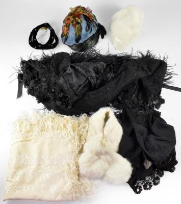A collection of Victorian and Edwardian ladies' clothing to include a Victorian lace, organza and silk black evening jacket, a Victorian children's black wool cape with embroidered trim, an Edwardian ivory Kashmiri embroidered shawl with silk fringing, two c1920s black feather boas, a c1920s ivory rabbit fur collar and a matching ivory rabbit fur and silk satin cloche hat, a black velvet and beaded headband and a similar period multicolour feather cloche.