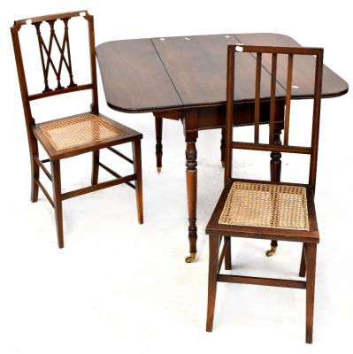 A 19th century mahogany drop-leaf table to turned tapering supports and castors, diameter when extended 95cm and two non-matching Edwardian chairs, each with bergère seats (3).