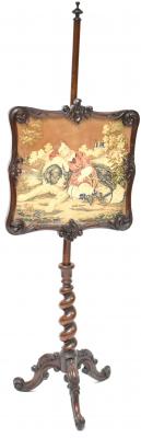 A 19th century mahogany pole screen with turned finial to the top, the screen with scroll and acanthus leaf decoration, tapestry panel of a young boy and dog sleeping in a Summer meadow with house in the distance, to a tapering wrythen and tripartite heavily decorated support, height 156cm.