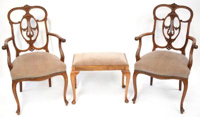 A pair of late 19th/early 20th century walnut armchairs with floral pierced splat, scroll arms and upholstered seats, on cabriole legs, also a similar upholstered dressing table stool (3).
