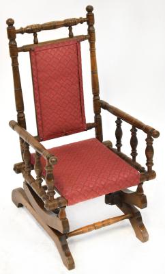 A late 19th/early 20th century child's bobbin turned rocking chair with upholstered seat and back.