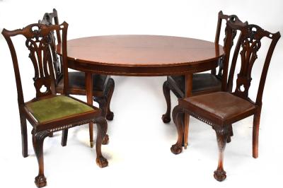 A reproduction mahogany extending dining table containing a single pop-up leaf, on tapering supports and brass castors, and a set of four Chippendale-style dining chairs with carved frieze detail, raised on cabriole legs to ball and claw feet (5).
