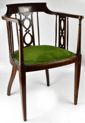 An Edwardian mahogany desk chair with string inlaid back rail, Celtic-style motif back splat and side supports, with turned columns, scroll end arms, upholstered padded seat, raised on square tapering supports and cabriole back legs.