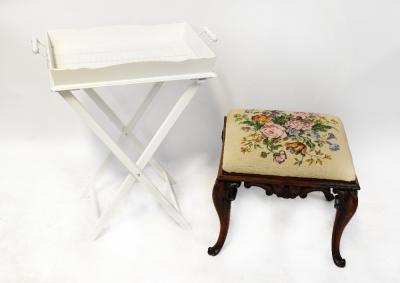 A Victorian mahogany stool with tapestry upholstered top in cream with bouquet of flowers, to base of Rococo style C-scrolls and cabriole legs, 45 x 48 x 41cm, together with a modern white painted wooden galleried twin-handled tray on folding stand (2).