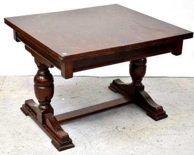 An early 20th century mahogany crossbanded draw-leaf dining table, raised on turned baluster supports united by a stretcher, when extended 75 x 180 x 99cm.