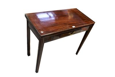 An early 20th century mahogany fold-over tea table with single frieze drawer, raised on square tapering supports, 75 x 91 x 45cm (af).