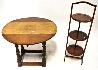An early/mid-20th century small oak drop-leaf side table to turned supports and cross-stretcher, diameter when extended 70cm and an Edwardian mahogany three-tier cake stand (2).
