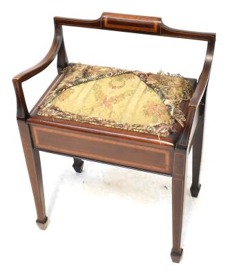 An Edwardian-style mahogany inlaid piano stool with shallow back rest and curved arms, above lift-up seat compartment, on square tapered supports.