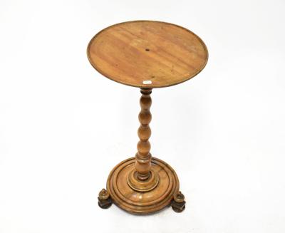 A 19th century mahogany circular top side table, on a turned column and circular base, raised on three bun feet, with knops, height 73cm, diameter 39cm.