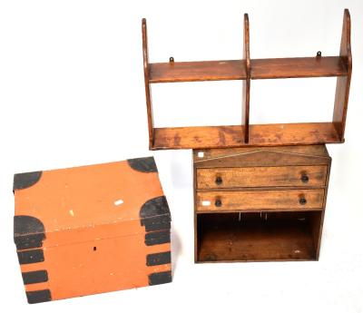 A late 19th/early 20th century mahogany set of wall-hanging shelves, with architectural-style pediment over two drawers, with an open shelf beneath, height 45cm, together with one other small stained pine open plate rack and a metal bound orange painted chest, 28 x 46 x 30cm (lacking key) (3).