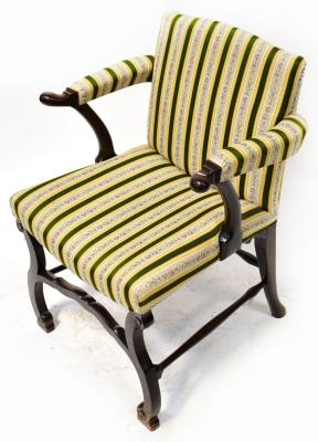 A 19th century mahogany parlour chair, upholstered in a green, yellow and cream floral striped material, with open arms and scroll ends, on a base with serpentine legs united by shaped stretchers, height 91cm.