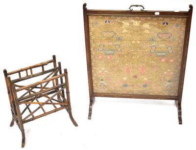 A 19th century mahogany framed fire screen inset with a needlework panel depicting Adam and Eve under the tree, the Serpent coiled around its trunk, within a floral border, the frame supported on outswept feet and with a brass carrying handle, 82 x 64cm, together with an Aesthetic Movement mahogany bamboo magazine rack of two sections, with carrying handle and on outswept legs, height 49cm (2).