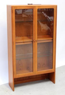 A G-Plan style twin-door glazed cabinet with one interior shelf, on slab-end supports, 144 x 81cm.