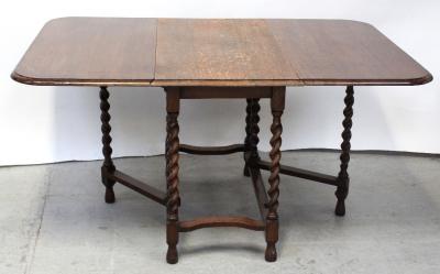 An early 20th century oak long leaf drop-leaf table on barleytwist supports, width 106cm.