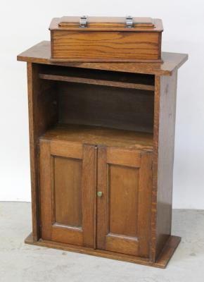 A small oak hall cabinet with bookshelf top over twin doors, height 79.5cm and a 1930s oak tie press collar box (2).