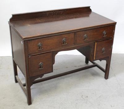 A small oak five-drawer desk on square legs with canted corners united by an H-stretcher, width 107cm.