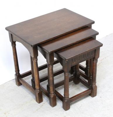A nest of three oak tables of rectangular form on turned legs united by peripheral stretchers, width of largest 58cm.
