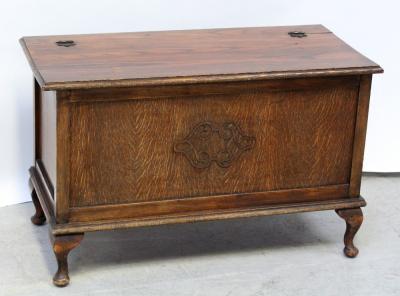 A mid-20th century oak blanket box/chest, raised central carving to front panel on cabriole supports.