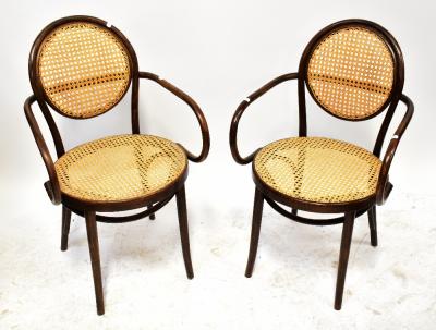 A set of four early 20th century bergère caned bentwood open arm elbow chairs, with circular seat pad and back panel (4).