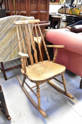 A late 19th/early 20th century stick back rocking chair with shaped arms, turned supports and H-stretcher, on rockers.