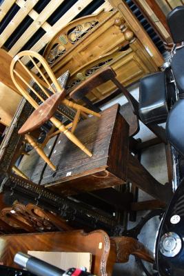An early 20th century school desk with integral chair and hinged writing slope, with pen tray and inkwell holder to the back section, 89 x 82 x 56cm approx, also a small children's stick back Windsor-style chair raised on turned stretchered supports (2).