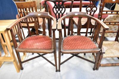 Two Edwardian mahogany desk/tub chairs with string inlay to back, arms and legs, upholstered seats with tacked edging, with cross stretchers (2).